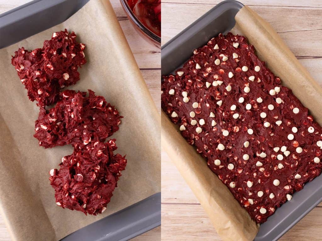 red velvet cookie bar mixture in metal pan lined with parchment paper