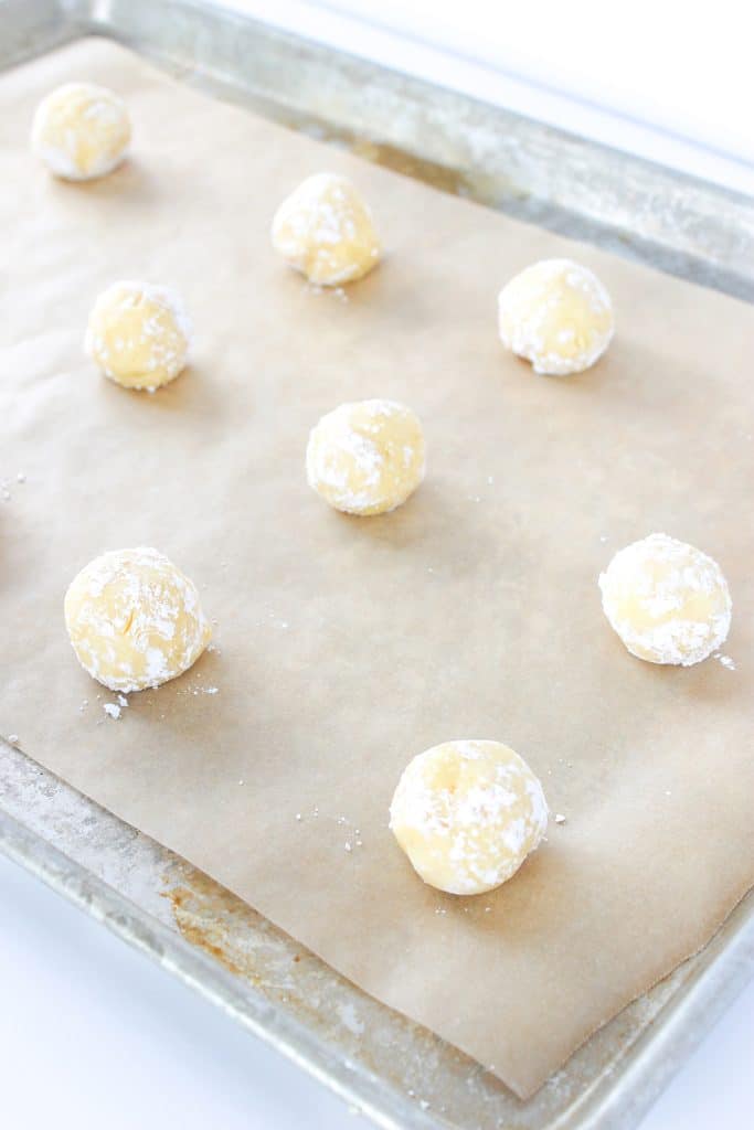 gooey butter cake cookie dough balls on baking sheet