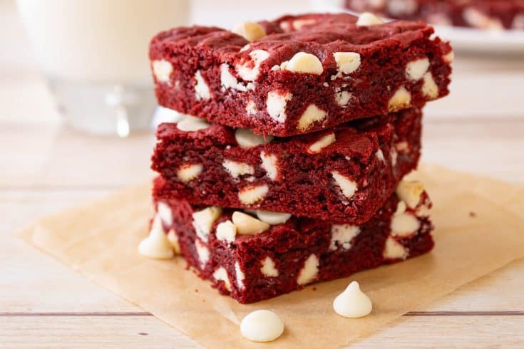 stack of cut red velvet cake mix cookie bars with white chocolate chips