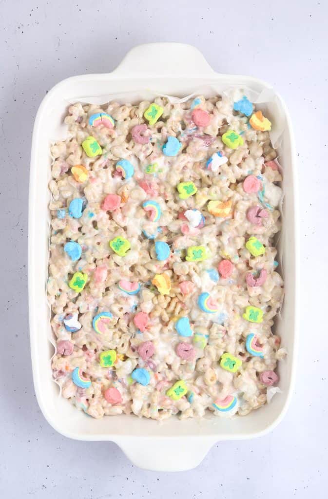 overhead shot of lucky charms marshmallow mixture pressed into a pan