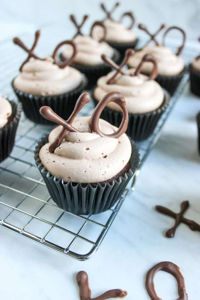 chocolate cupcakes with nutella buttercream frosting on wire cooling rack