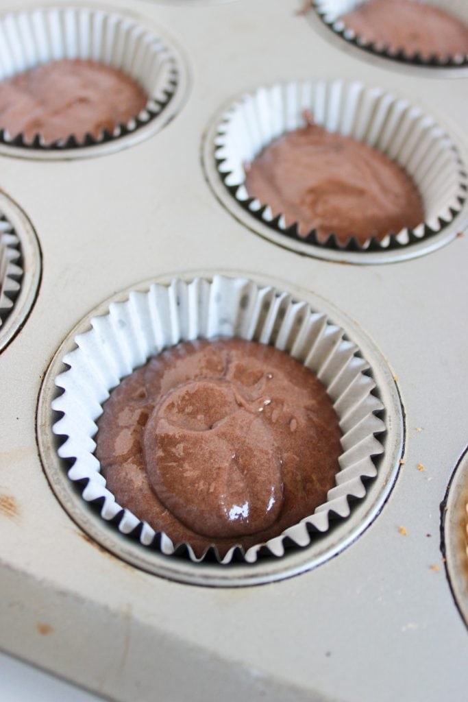 chocolate cupcake batter in lined cupcake tin