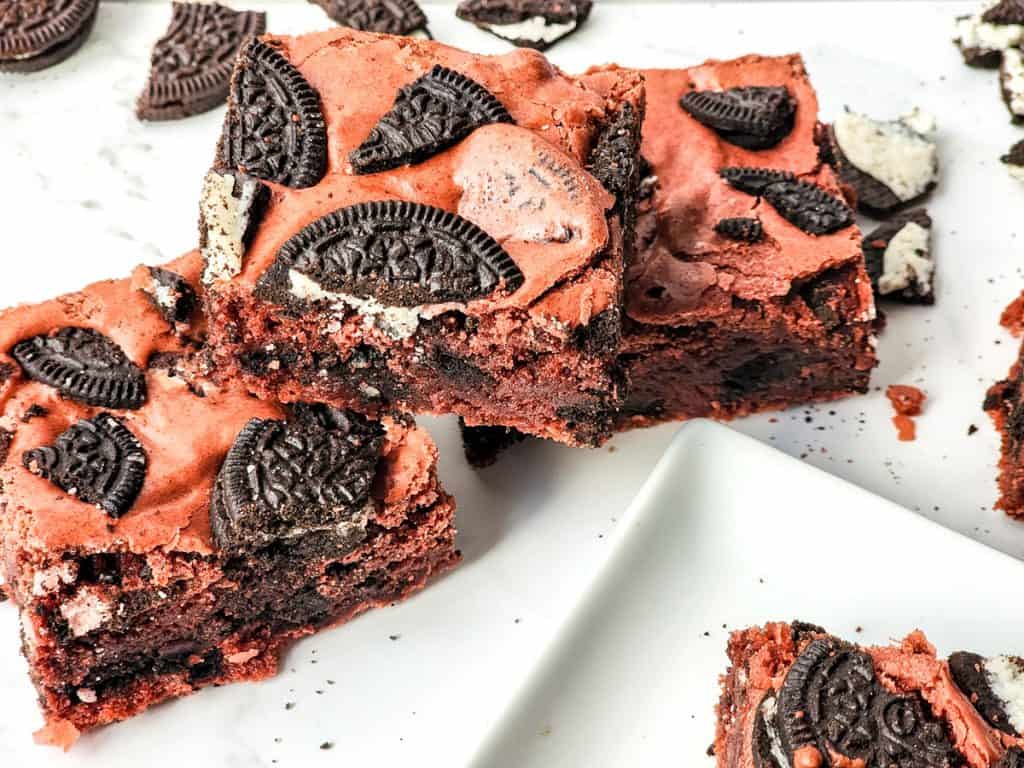 oreo red velvet brownies stacked on a counter