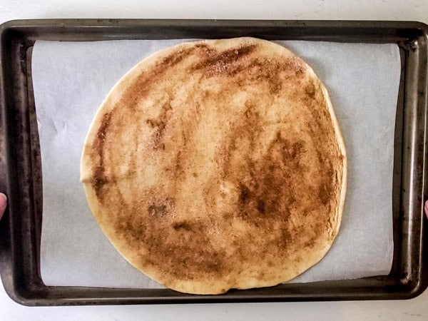 pie crust with butter, cinnamon, and sugar on a baking sheet