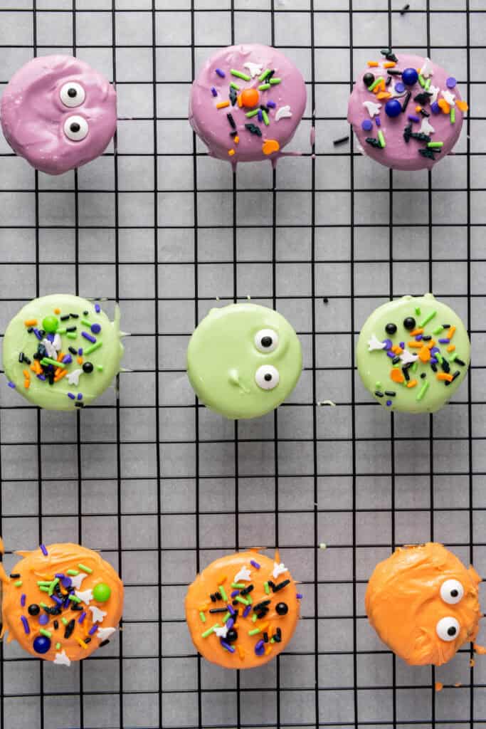 overhead shot of oreos with candy sprinkles on a baking rack