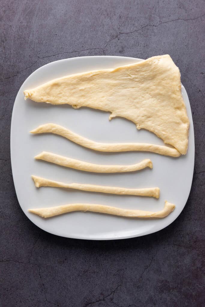 cutting the crescent rolls into strips