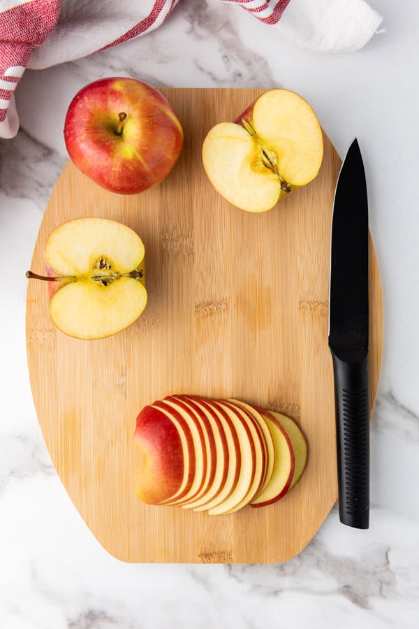 thinly sliced apples on a cutting board