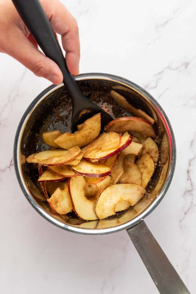 caramelizing the apples in a pan