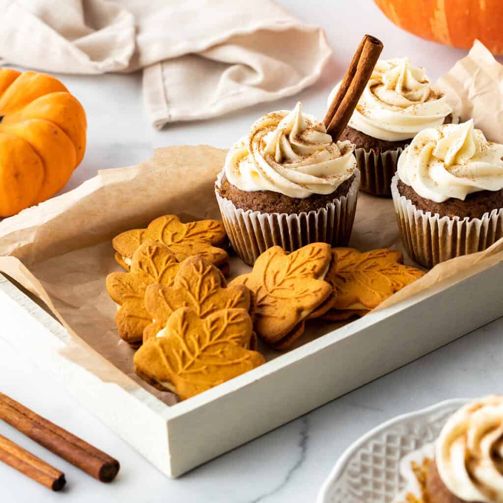 best desserts for thanksgiving roundup - cupcakes and cookies on a tray next to a pumpkin