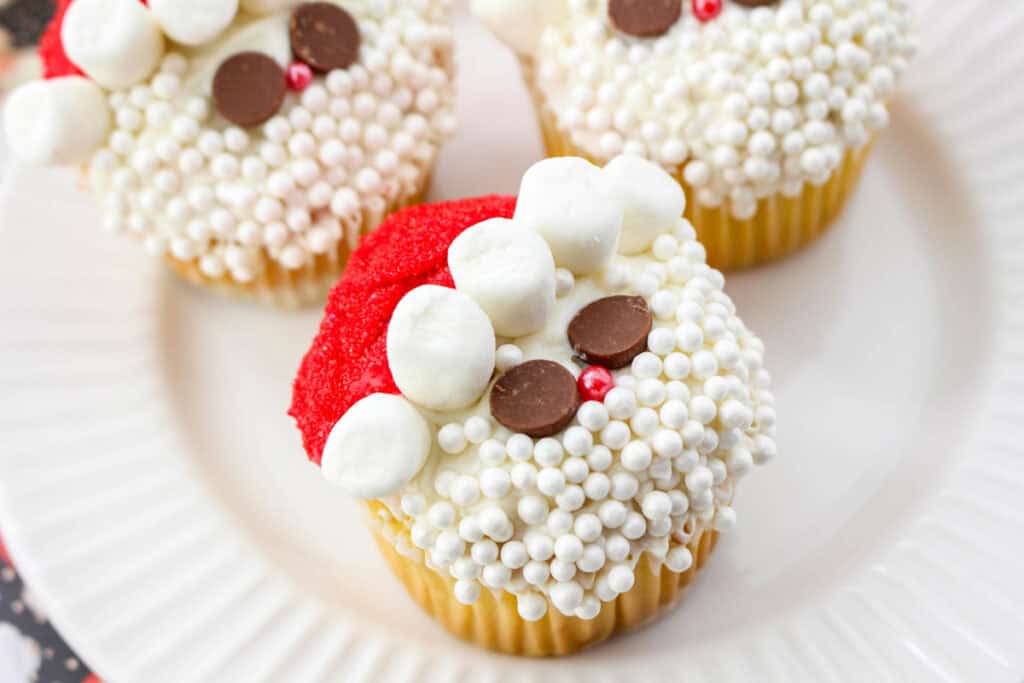 christmas cupcakes decorated like santa on a plate