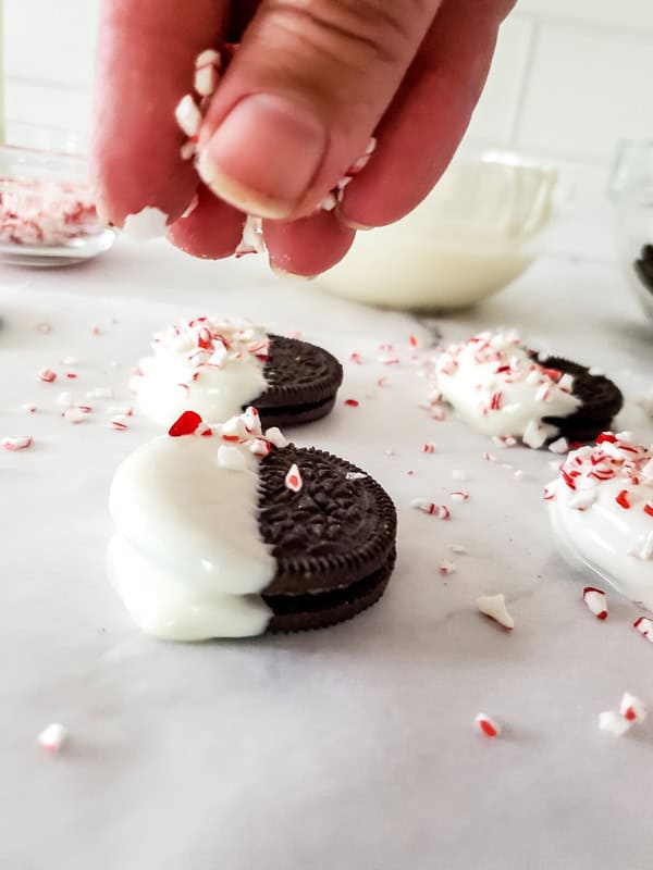 sprinkling peppermint on top of the almond bark