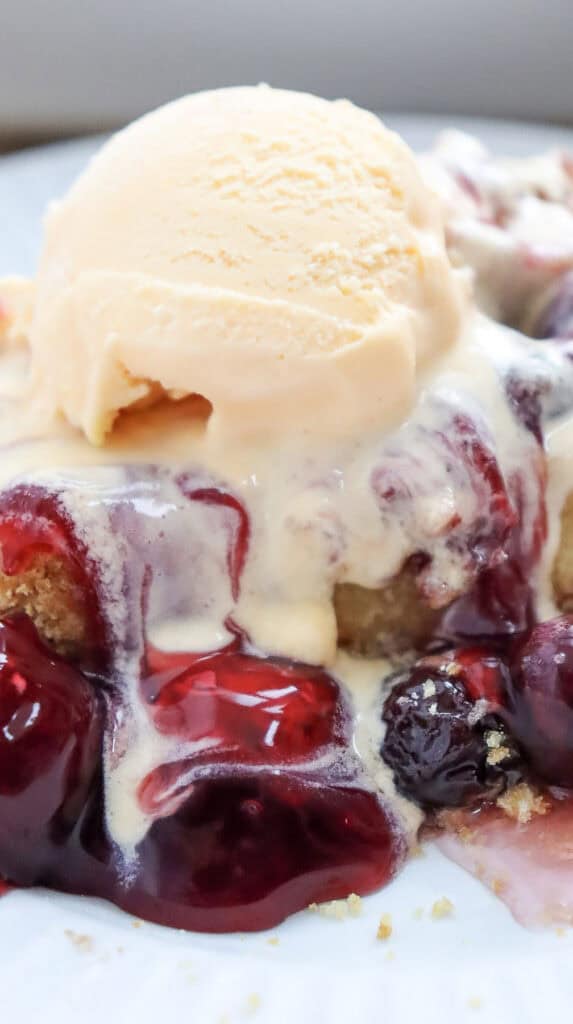 closeup shot of cherry dump cake on a plate