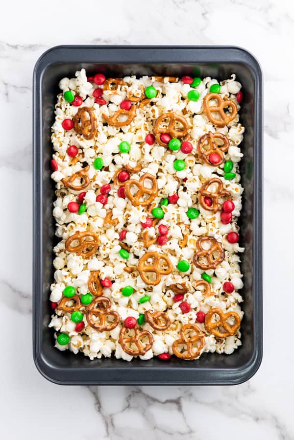 m&ms, pretzels, and popcorn in a baking dish