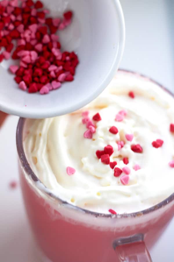 adding sprinkles on top of the whipped cream