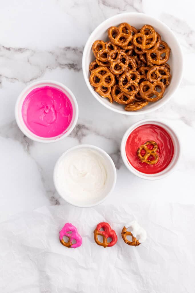 dipping the pretzels in melted candy