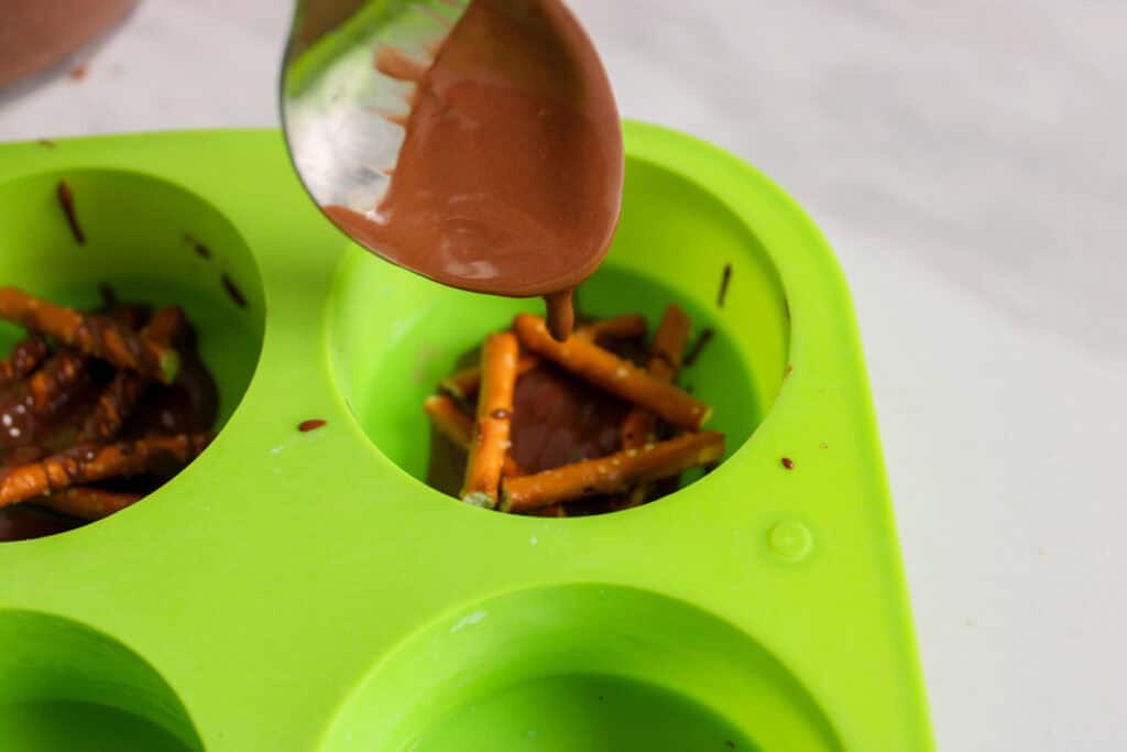 drizzling melted chocolate onto the pretzels