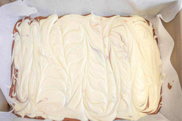 swirling the white chocolate on top of the milk chocolate layer