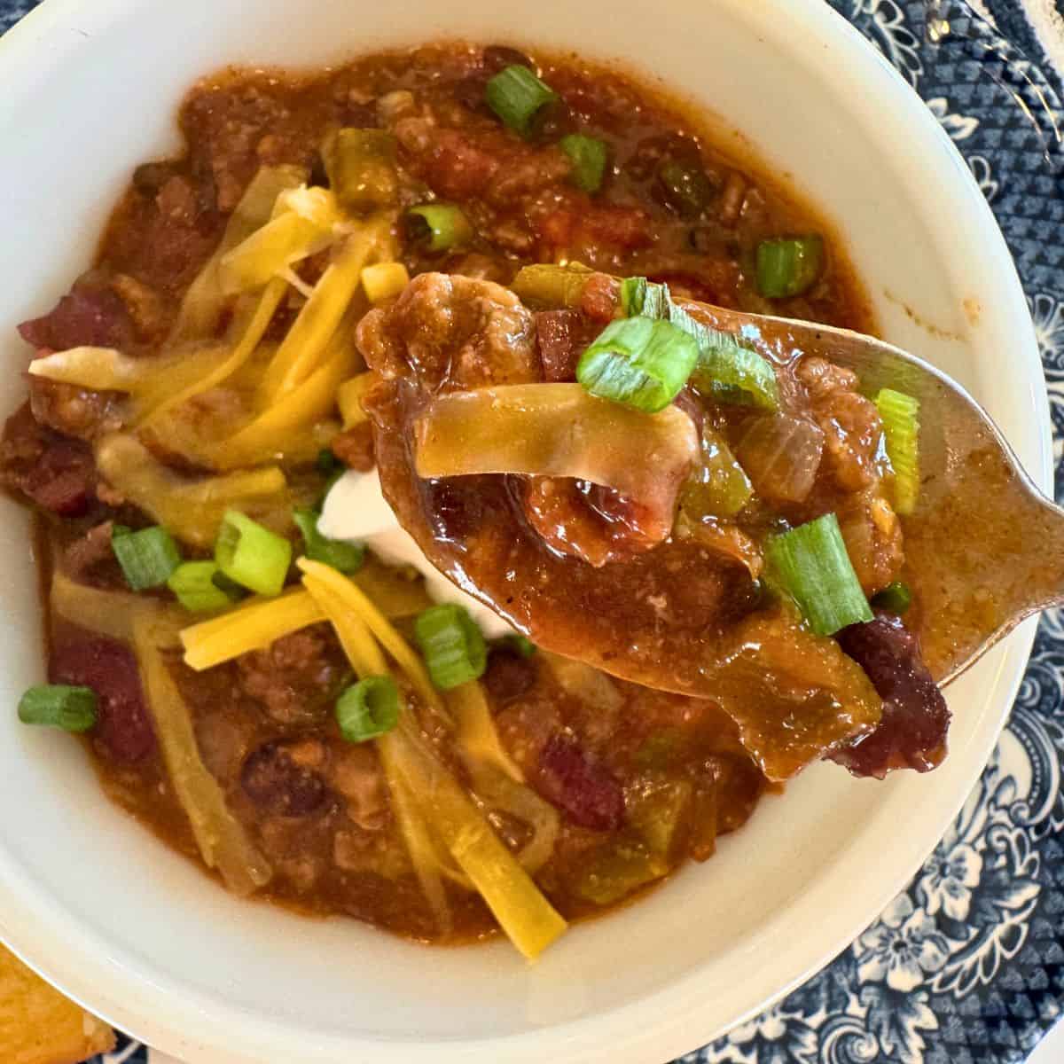 best crockpot chili recipe in bowl with spoonful to show