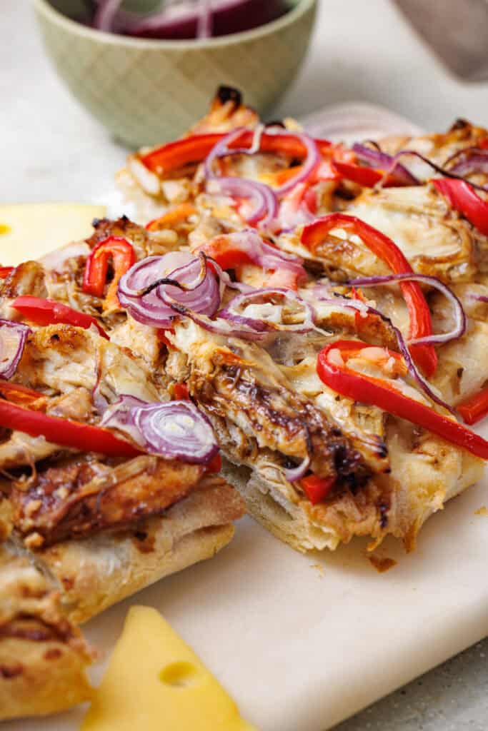 closeup of finished bbq chicken flatbread after cutting