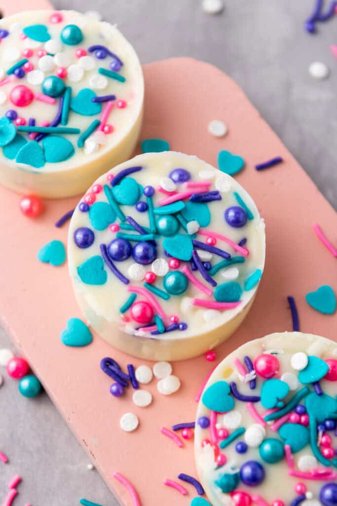 closeup of finished white chocolate oreos with sprinkles