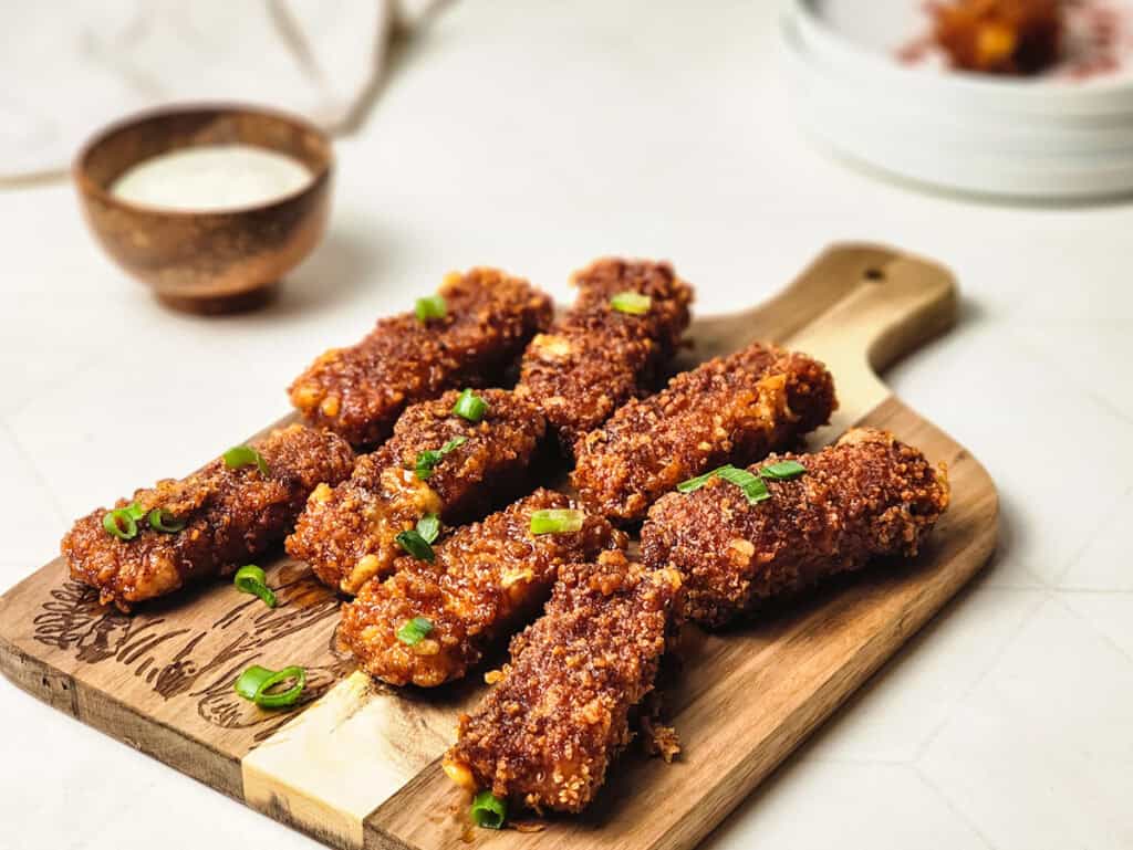 nashville hot mozzarella sticks on a cutting board