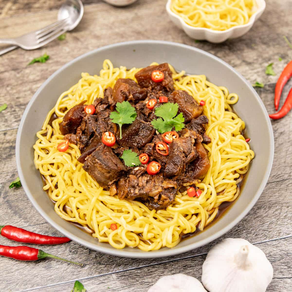 savoury thai beef stew over noodles