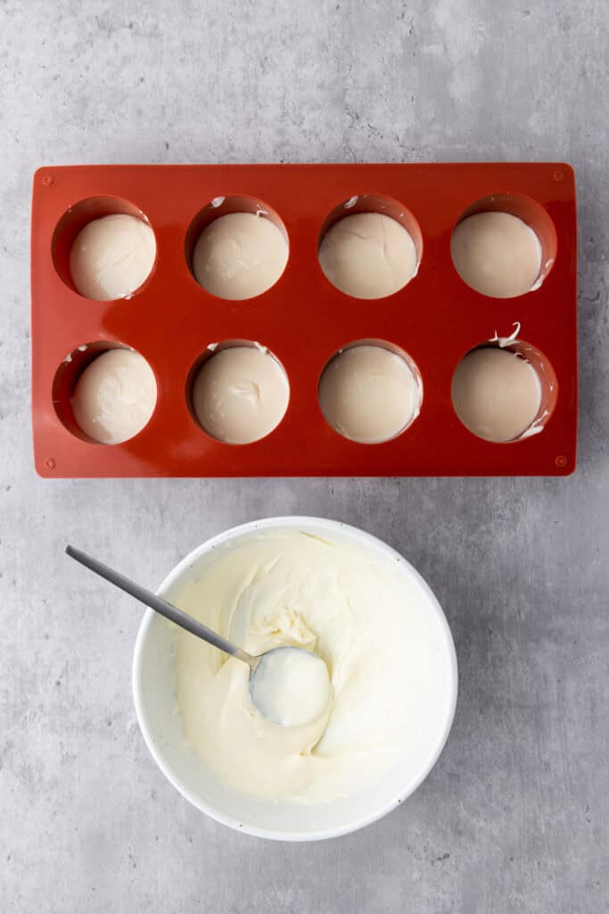 scooping the white chocolate into the mold