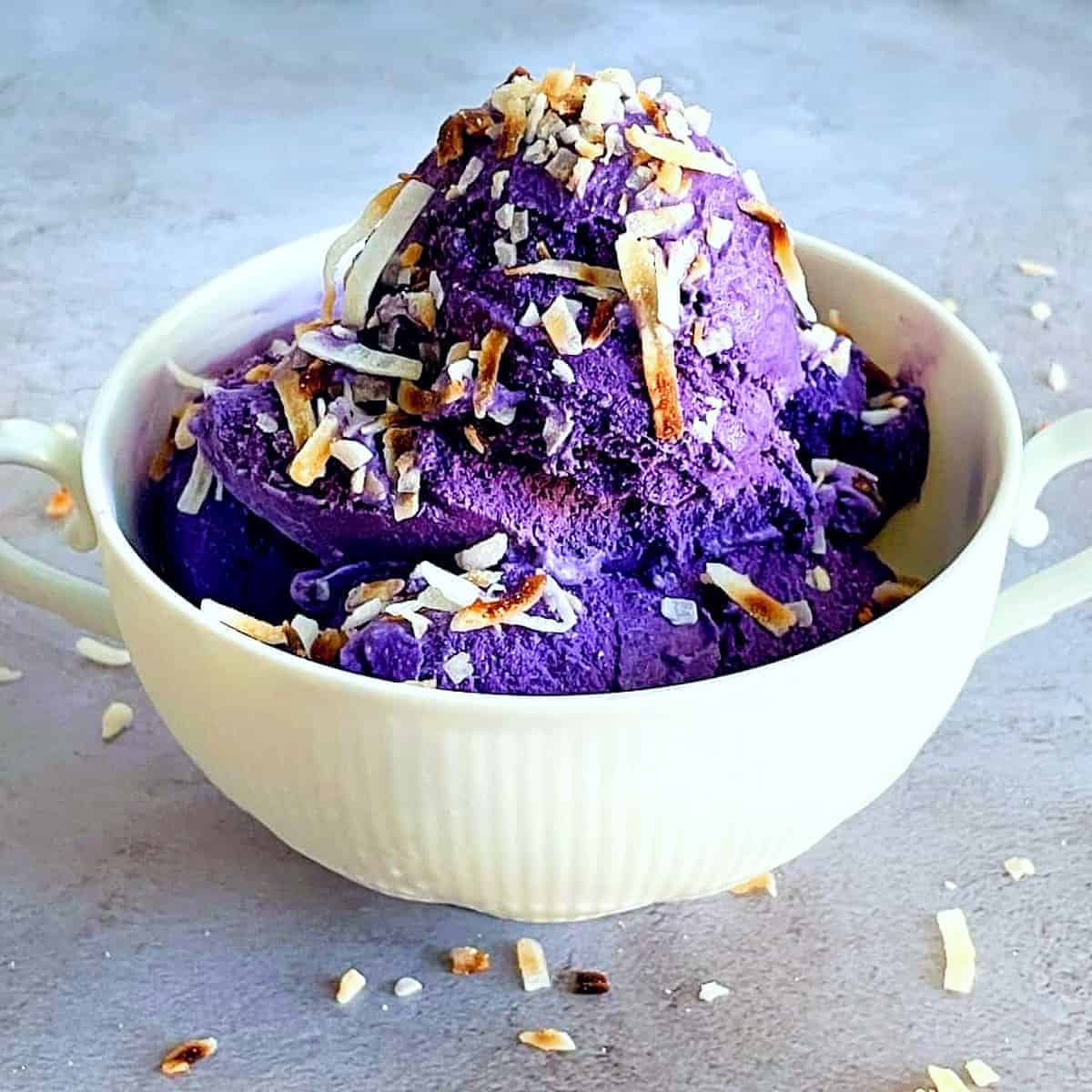 ube ice cream in a bowl with toasted coconut on top 1