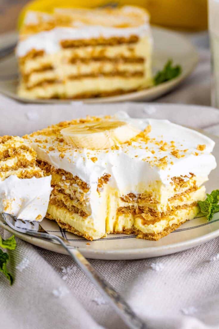 Banana Icebox Cake on a plate with a forkful taken Custom