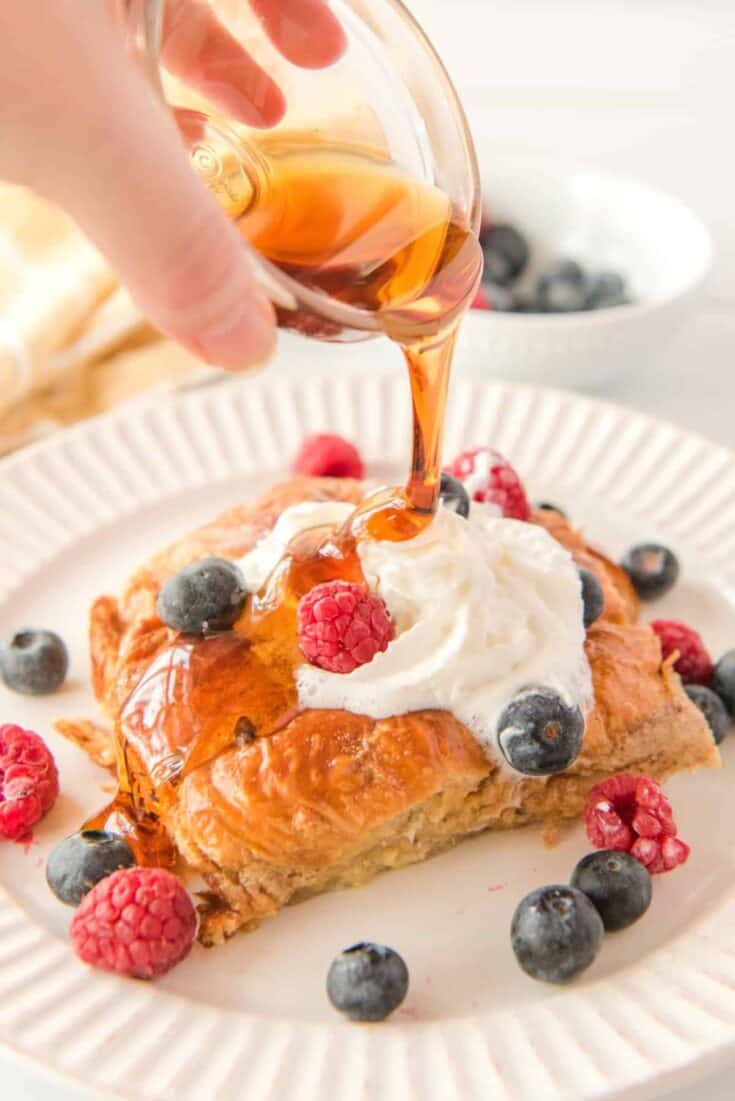 Croissant French Toast Bake pouring maple syrup on27 Custom