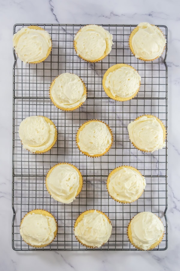 adding the frosting to the cupcakes