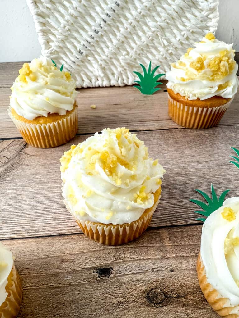 closeup of the pineapple crunch topping on top of finished cupcakes