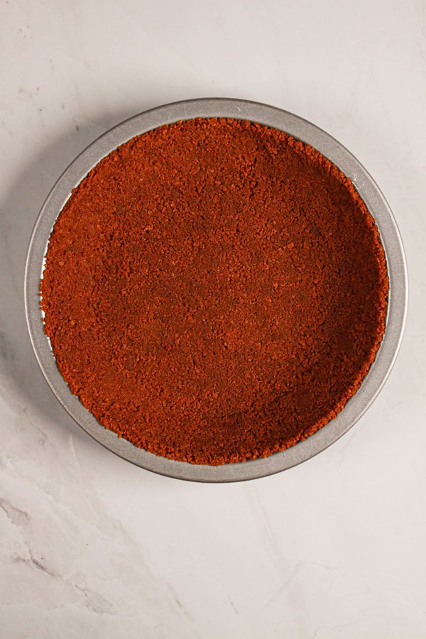 biscoff cookie crust pressed into the bottom of a baking dish