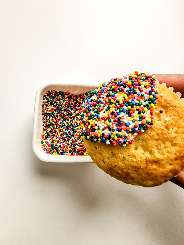 dip the white frosting into the sprinkles to create people 