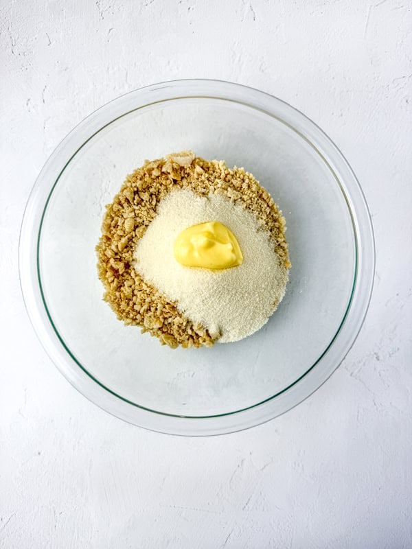 add cookie crumbles, butter, and jello mix to a bowl.