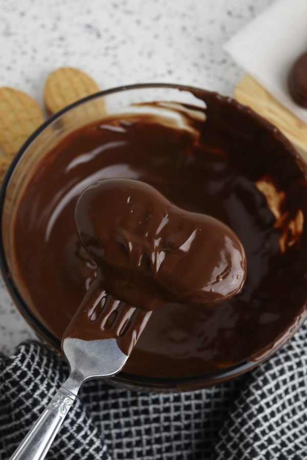 allow excess melted chocolate to drip off the cookie before placing it on parchment paper.