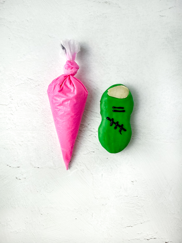 melt the pink candy and put it in a piping bag