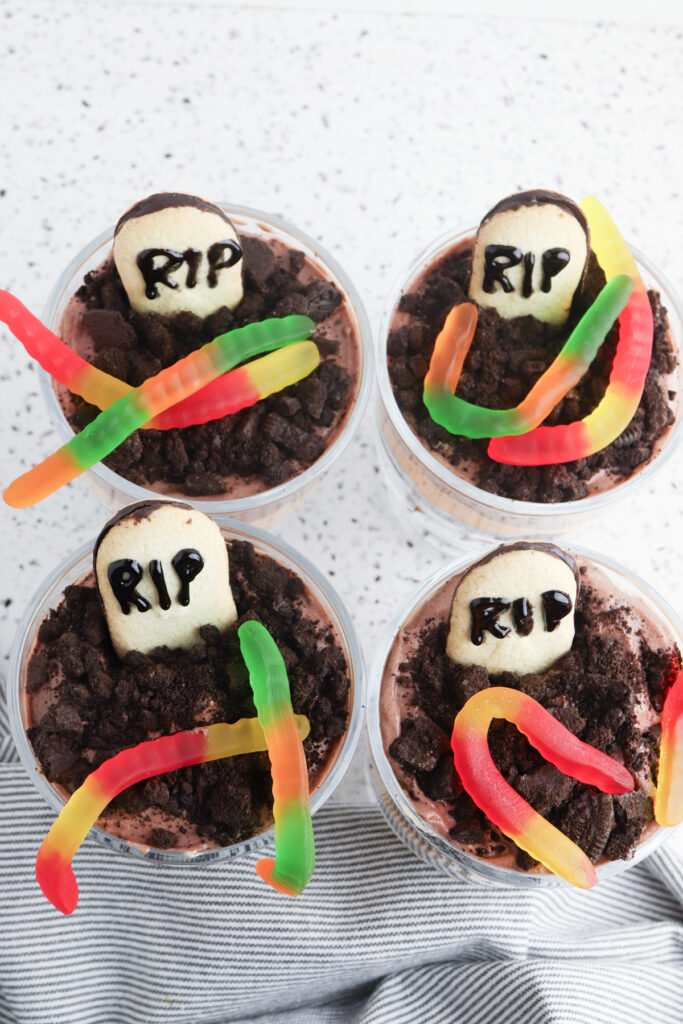 add cookies and gummy worms on top of oreo layer