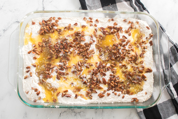 add pecans and melted margarine on top of cake mix