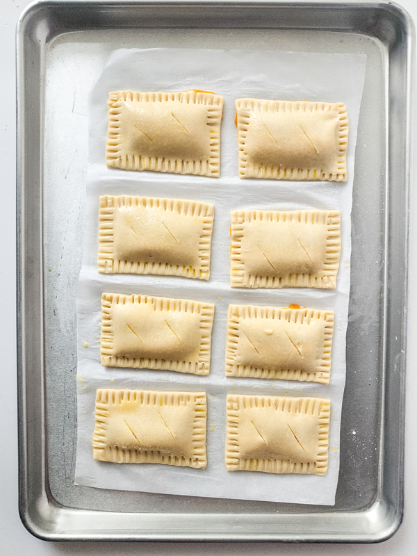 crimp edges of pies and cut slits on top