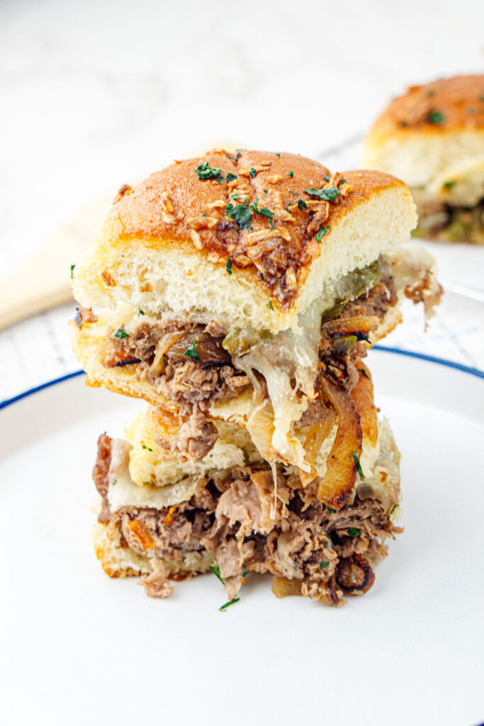 stack of philly cheesesteak sliders on a plate