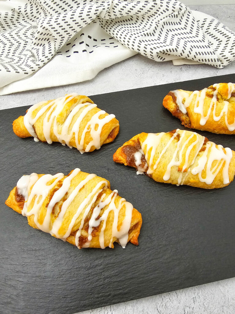 pumpkin crescent rolls after baking and drizzled with icing