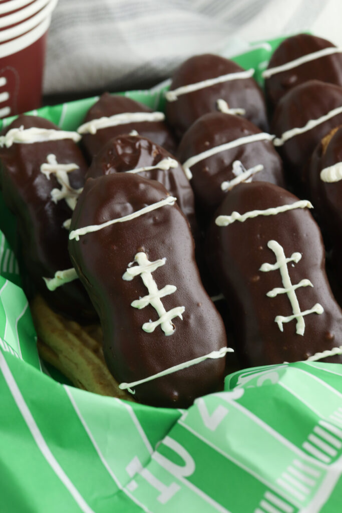 chocolate covered football cookies in a basket