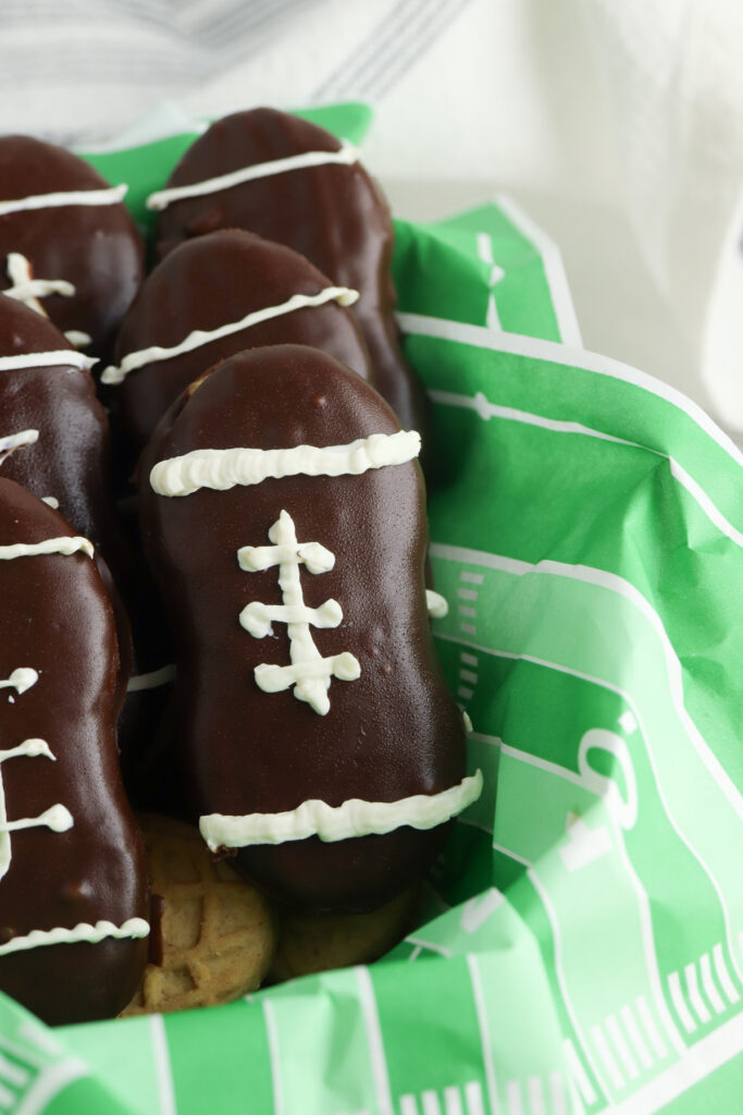 closeup shot of the finished football cookies in a basket