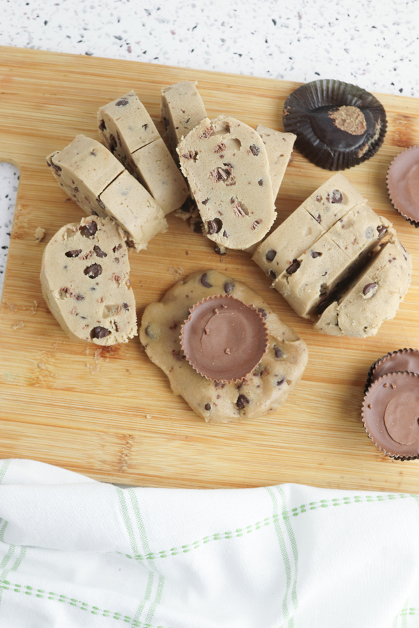 place a peanut butter cup in the center of a slice of cookie dough