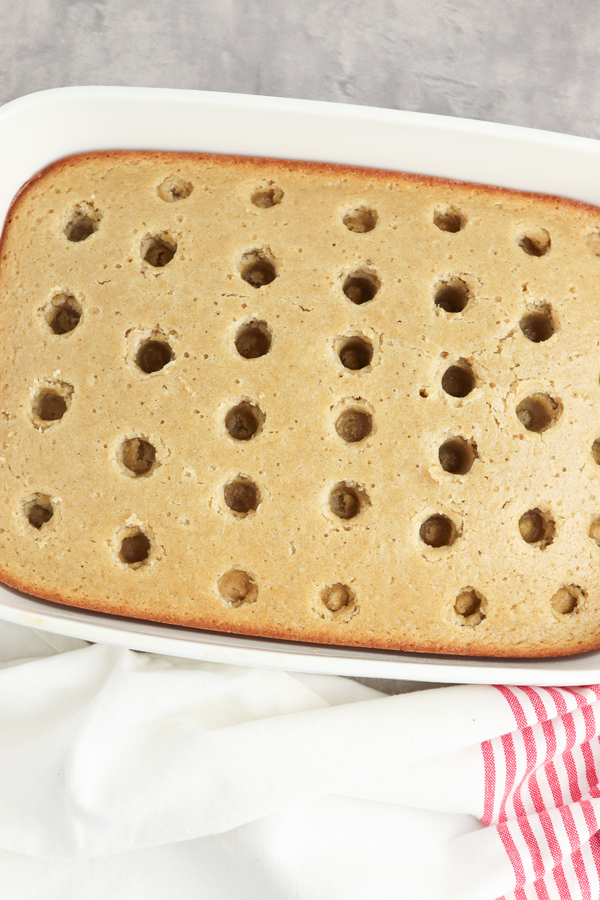 poke holes in the cake with a wooden spoon