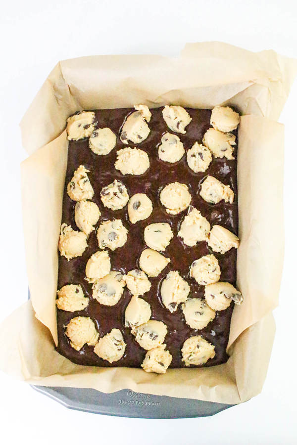 add spoonfuls of cookie batter to brownie batter in pan