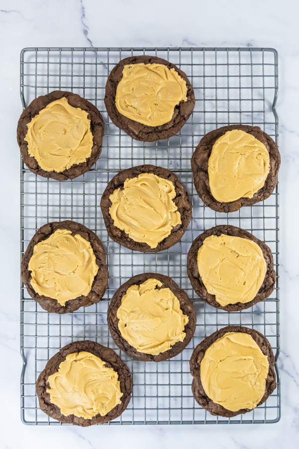 top the brownie cookies with peanut butter frosting