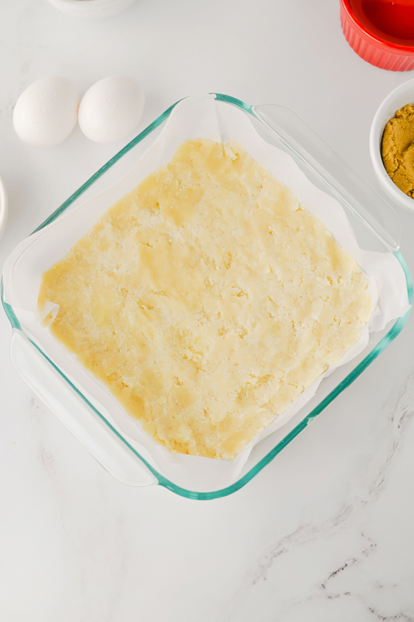 press the crust into a parchment lined baking dish