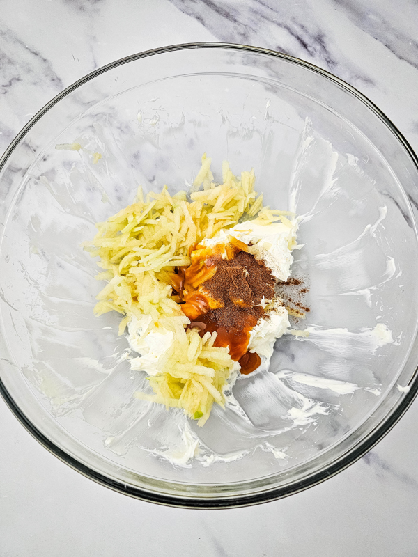 add shredded apple, caramel sauce, and cinnamon to cream cheese mixture
